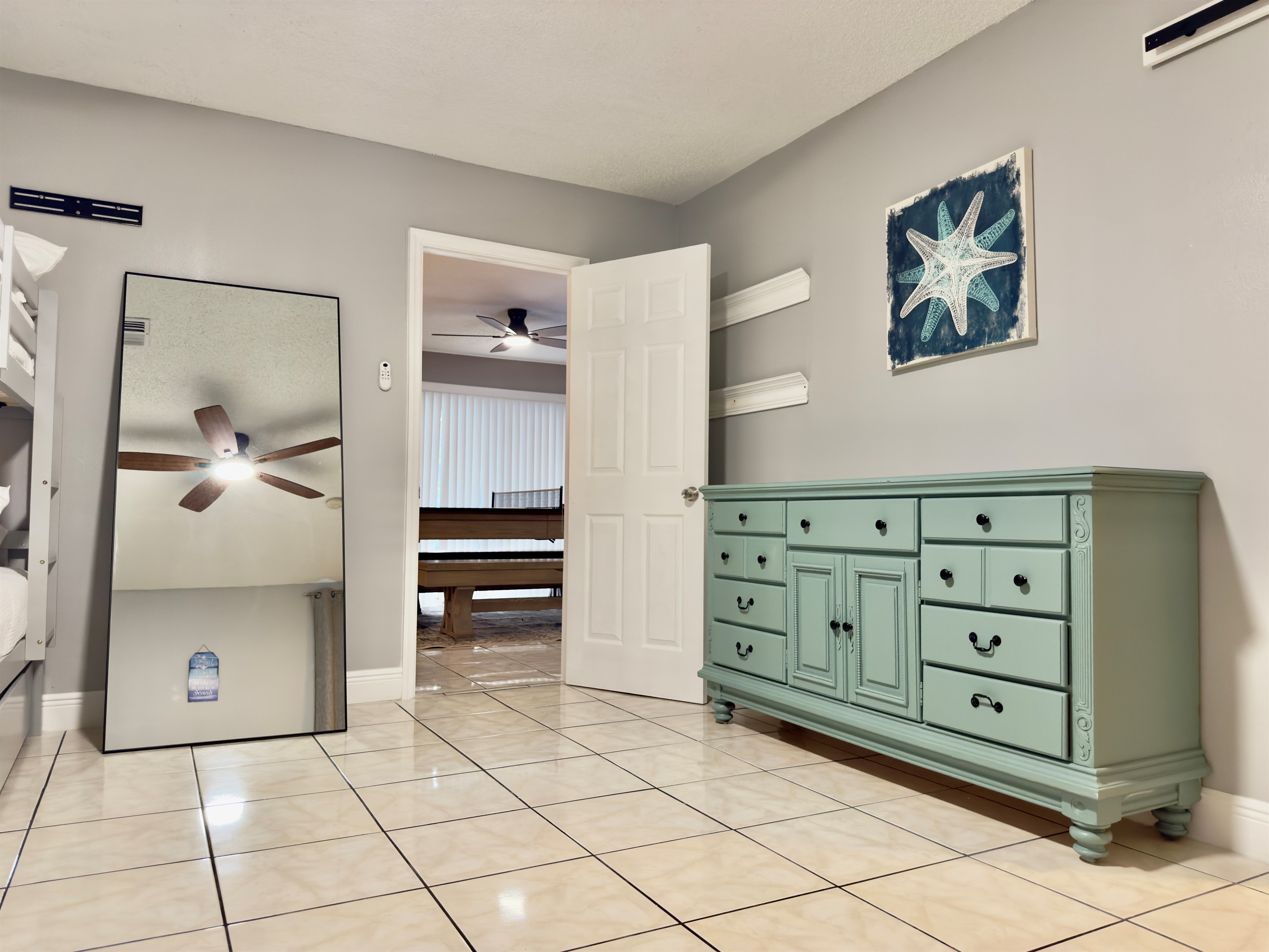 A classic dresser adds storage for clothes and travel essentials, while the floor space offers plenty of room to unpack and stretch out.