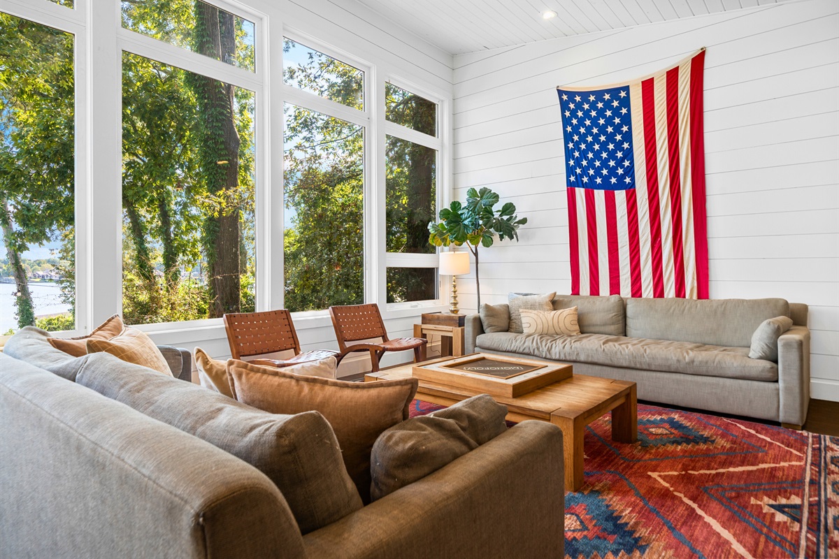 Living room with big comfy couches and floor-to-ceiling windows on the lake.