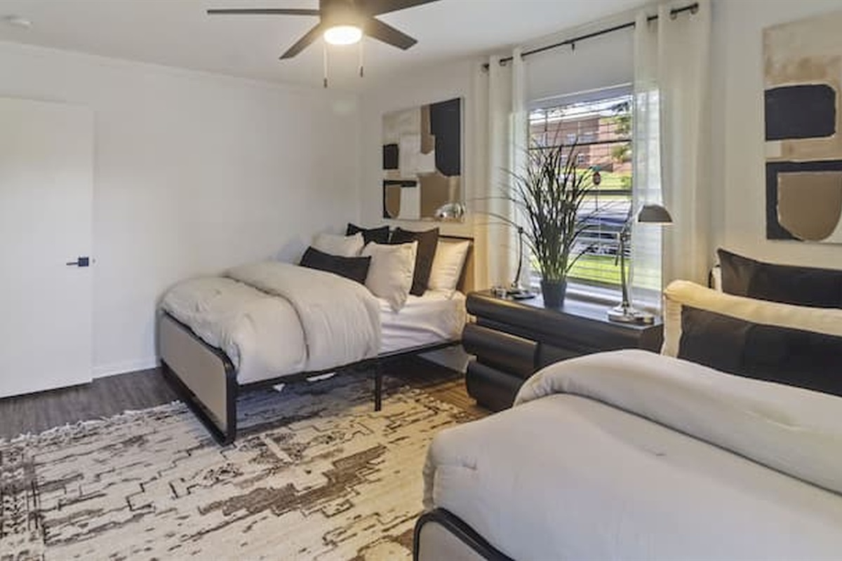 Spacious double queen bedroom with flexible sleeping arrangements for groups and families.