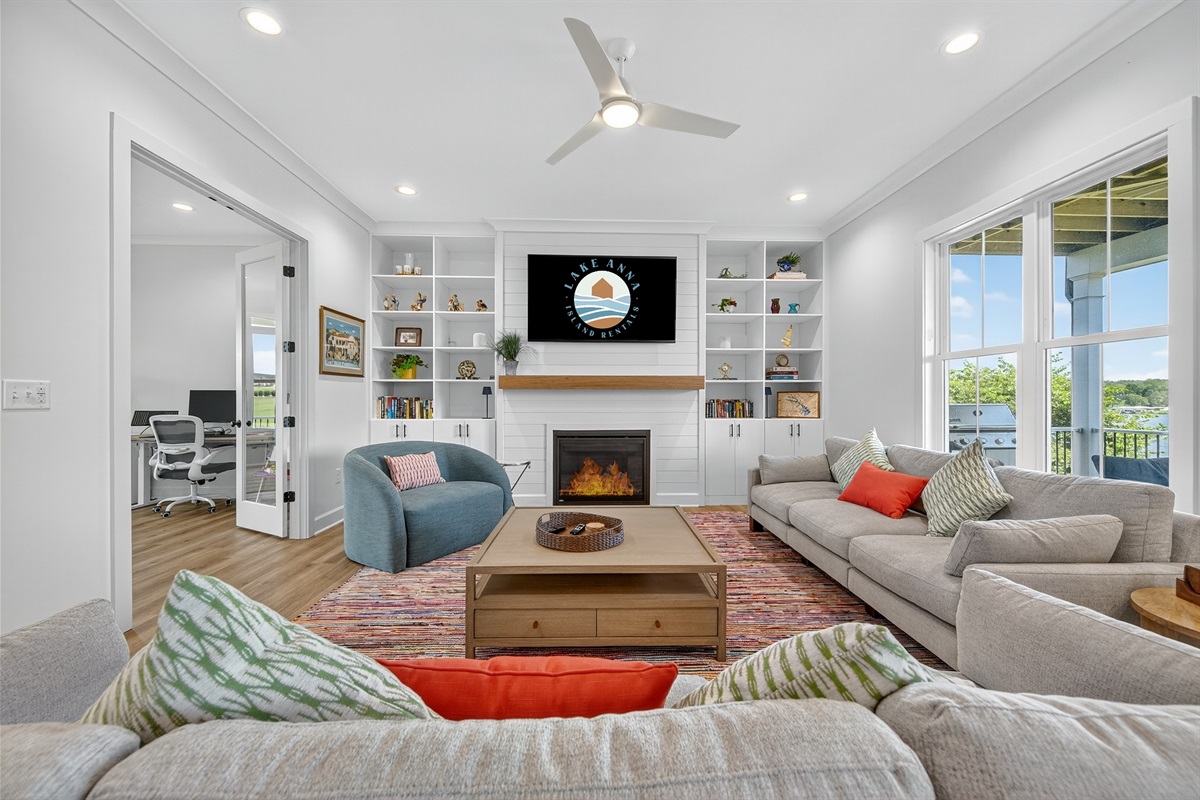 Gather and relax in the spacious living room with vaulted ceilings, comfy couches, and big windows.