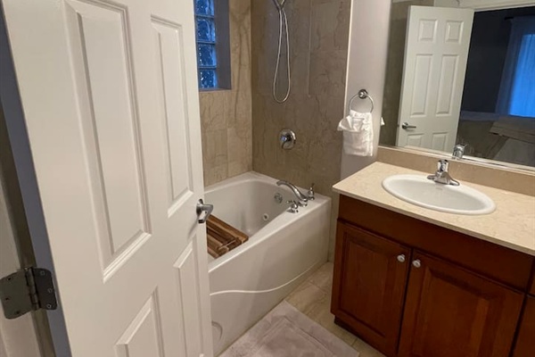 Clean bathroom with shower and fresh towels provided.