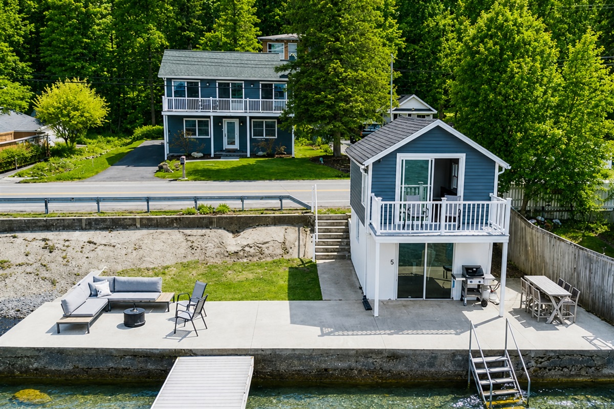 Charming two-story vacation rental with a private driveway, fresh landscaping, and modern curb appeal—perfectly situated in the heart of the Finger Lakes! 🏡🌲🚗