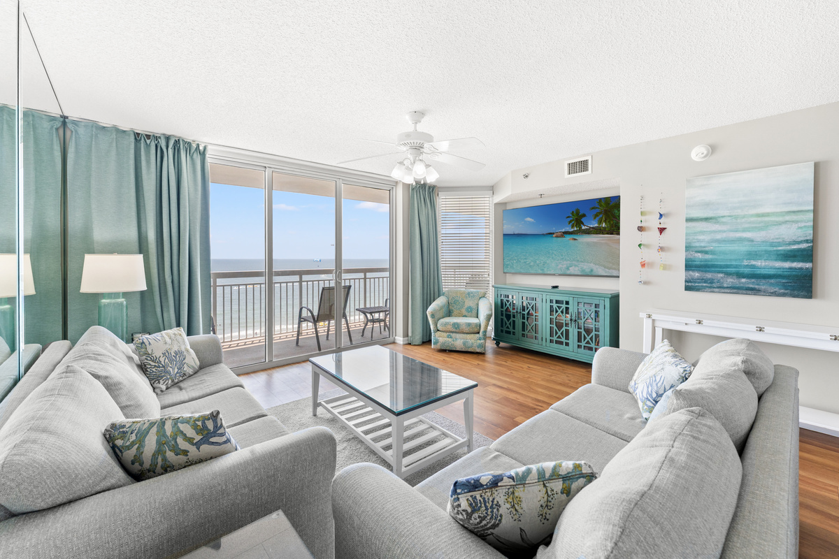 Oceanfront Spacious Living Room with balcony access and large TV