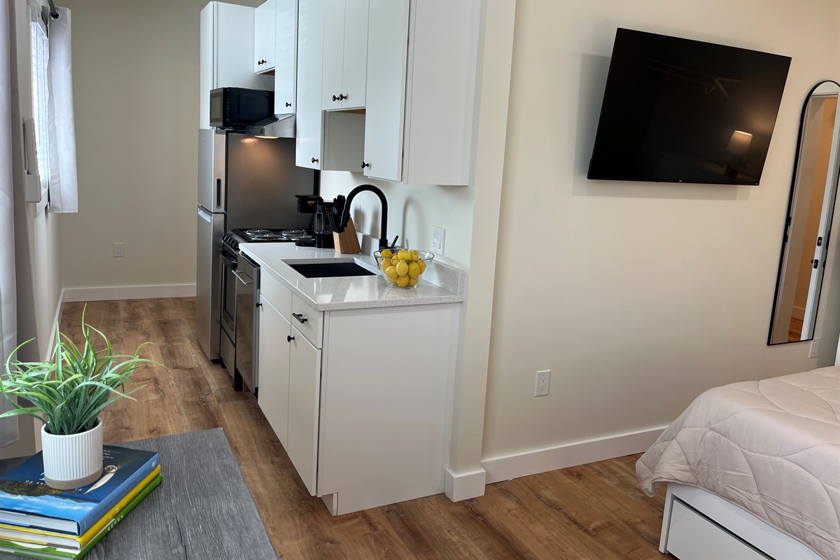 Galley kitchen leading to bathroom