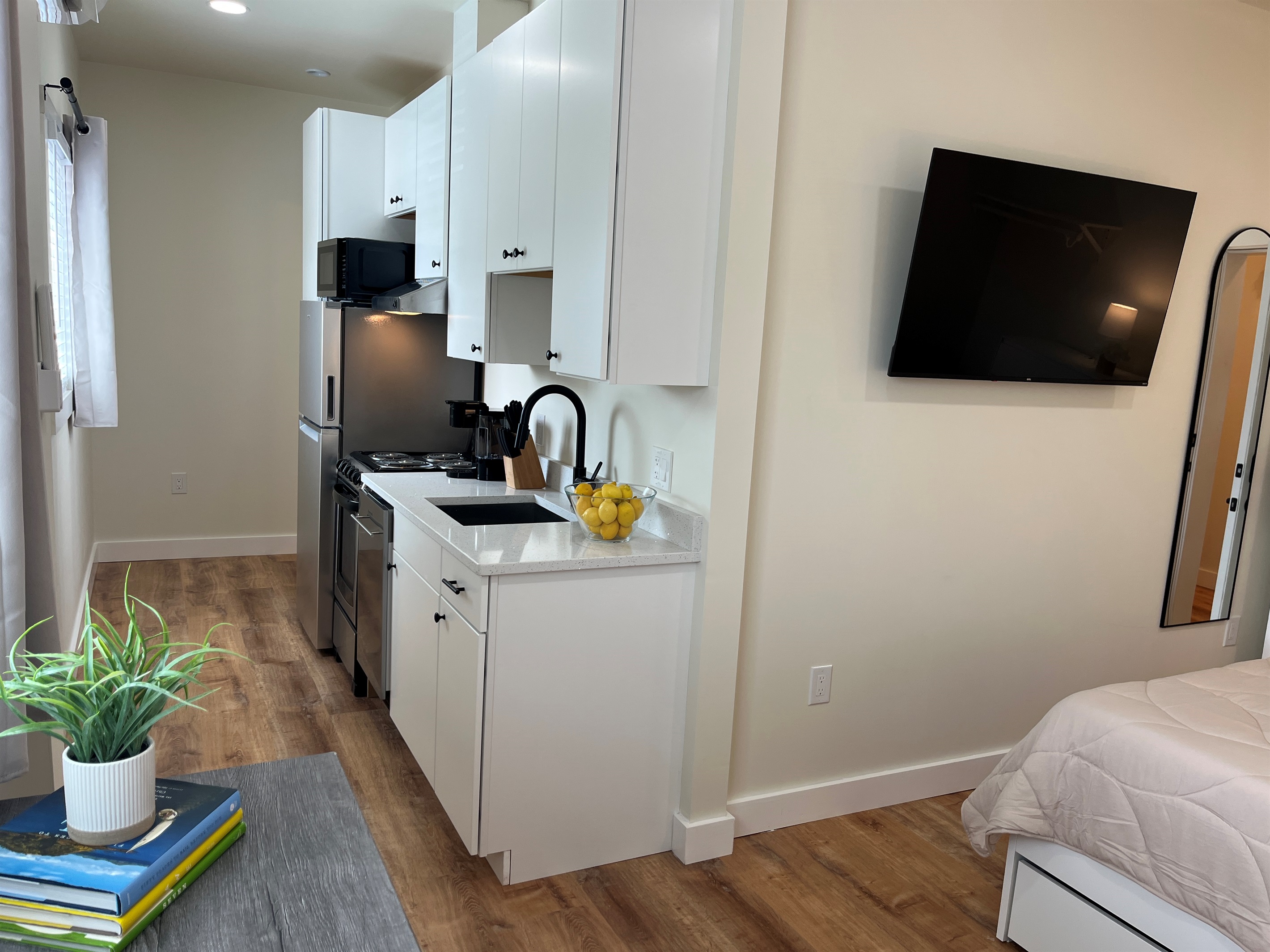 Galley kitchen leading to bathroom