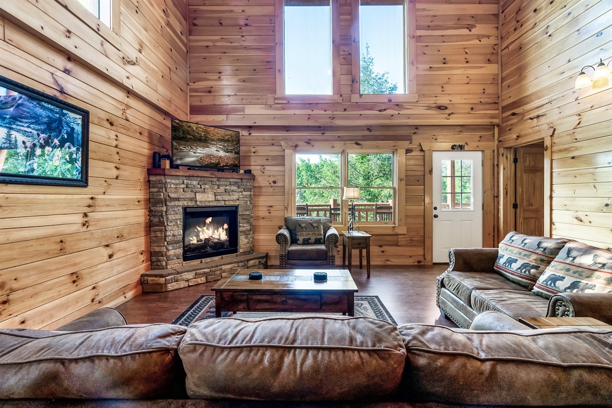 Relax together in the light filled living room where vaulted ceilings, warm wood, and mountain charm set the tone.