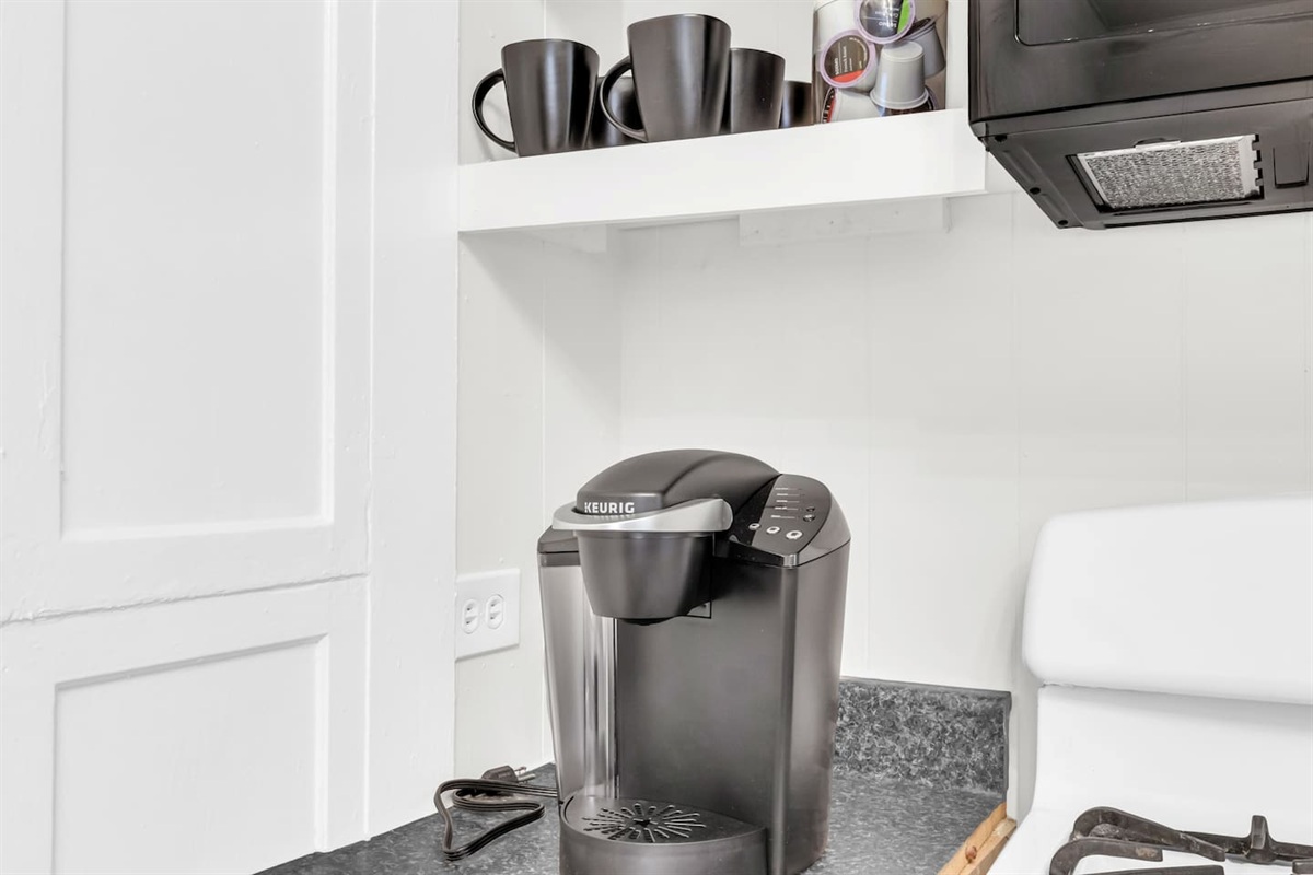 Coffee station with Keurig and mugs for your morning brew.
