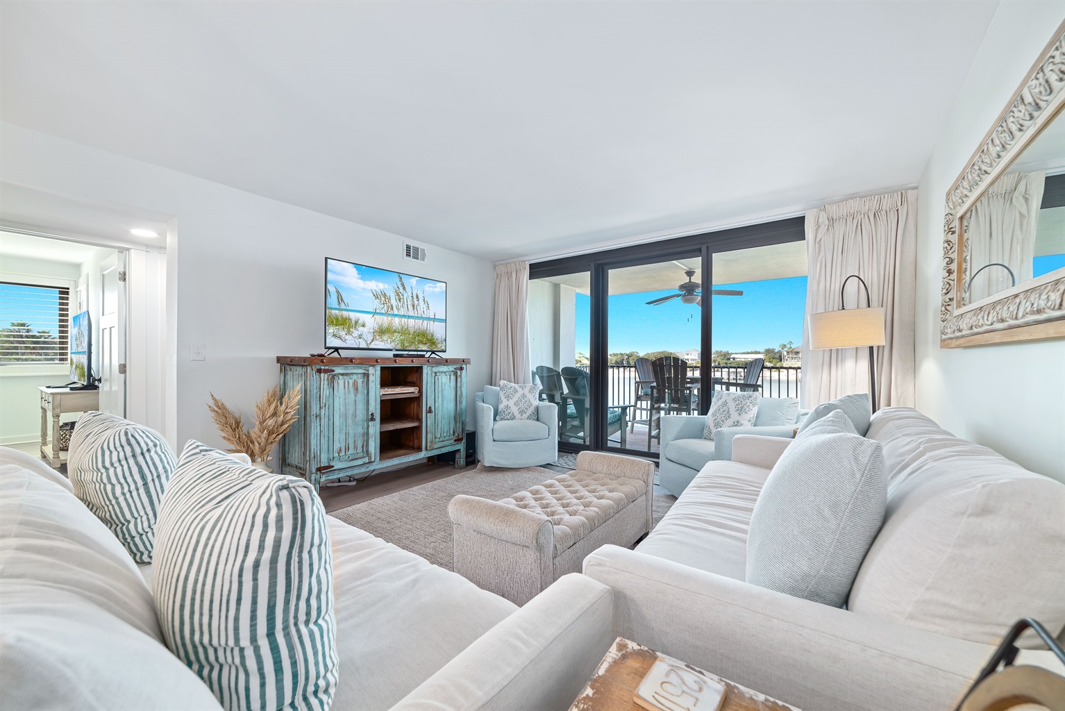 Spacious and inviting living area with floor-to-ceiling windows showcasing breathtaking views. This open-concept design seamlessly blends comfort and style, creating the perfect space for relaxation and entertainment.