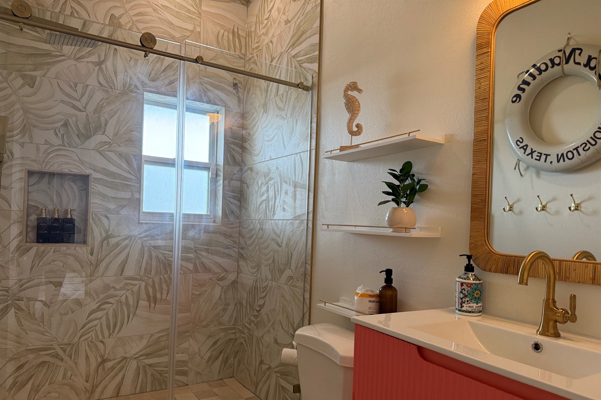 The hall bathroom has a walk in shower and plenty of hooks for towels.