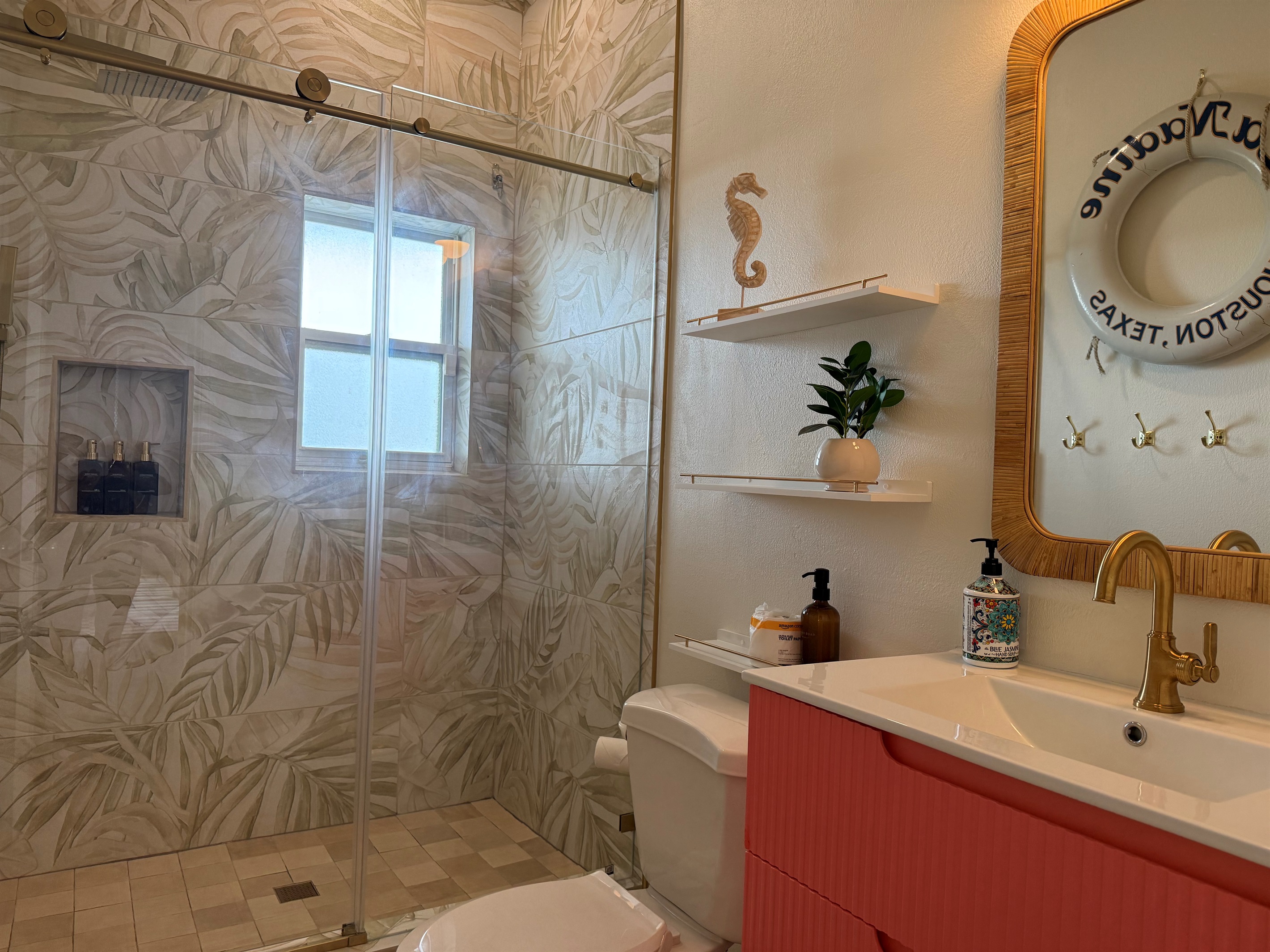 The hall bathroom has a walk in shower and plenty of hooks for towels.