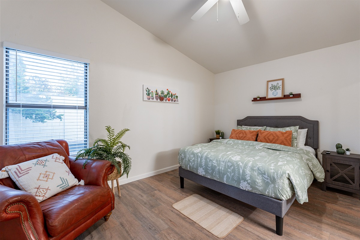 Primary bedroom with queen size gel foam mattress and reading chair.