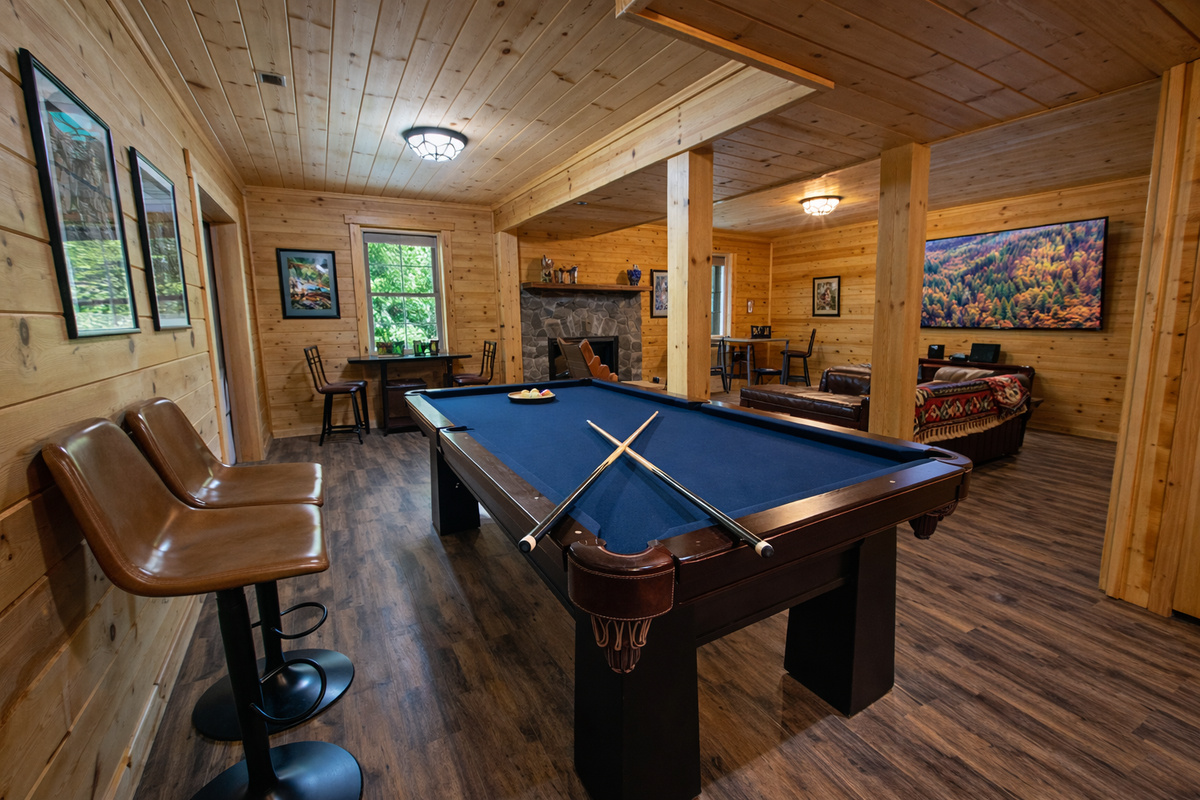 Amazing game room with pool table, retro arcade, Infinity table, and 70" Roku TV