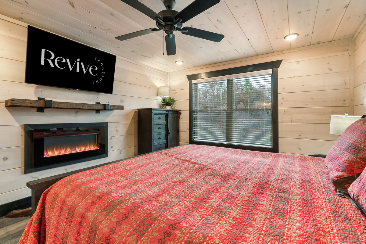 Upper-level king bedroom with a private en suite and cozy fireplace.
