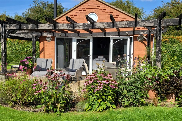 Annex games & entertaining, with logburner, seating & grill area.