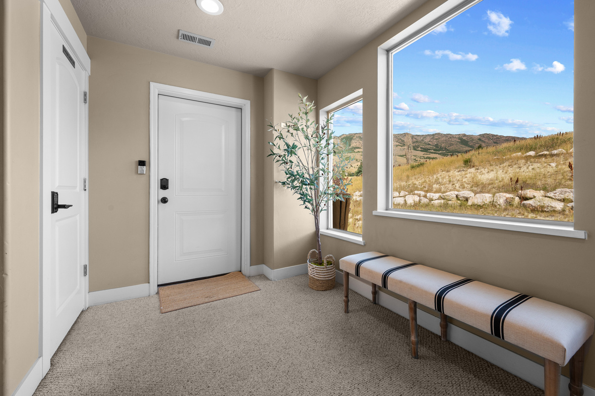 Windows throughout the entry areas highlight the beautiful landscape surrounding the property.