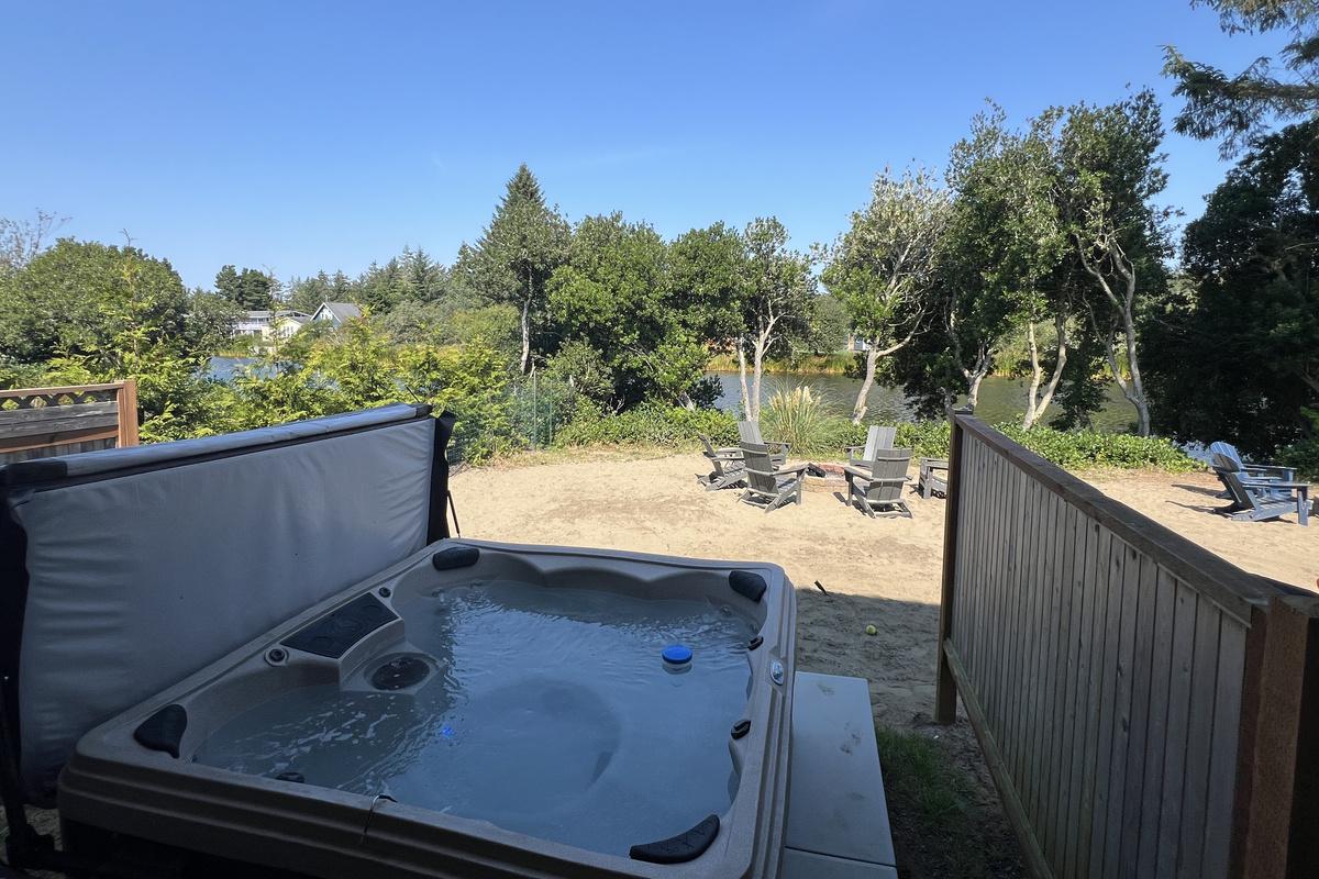 Slide into the hot tub while the sun's still out — the privacy fence and trees make it feel like your own hideaway.