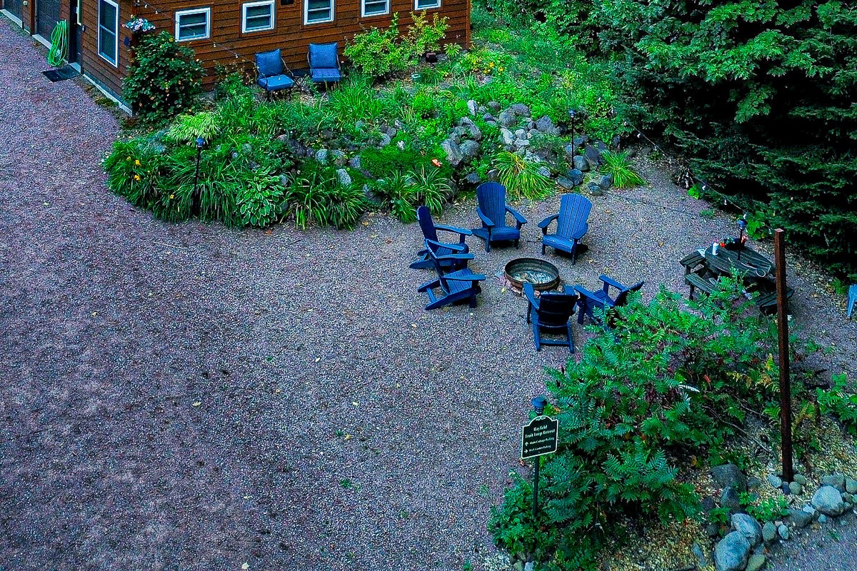 Rock Garden Cottage view from a drone high viewpoint feature fireplace and rock garden with perennial garden , many windows 