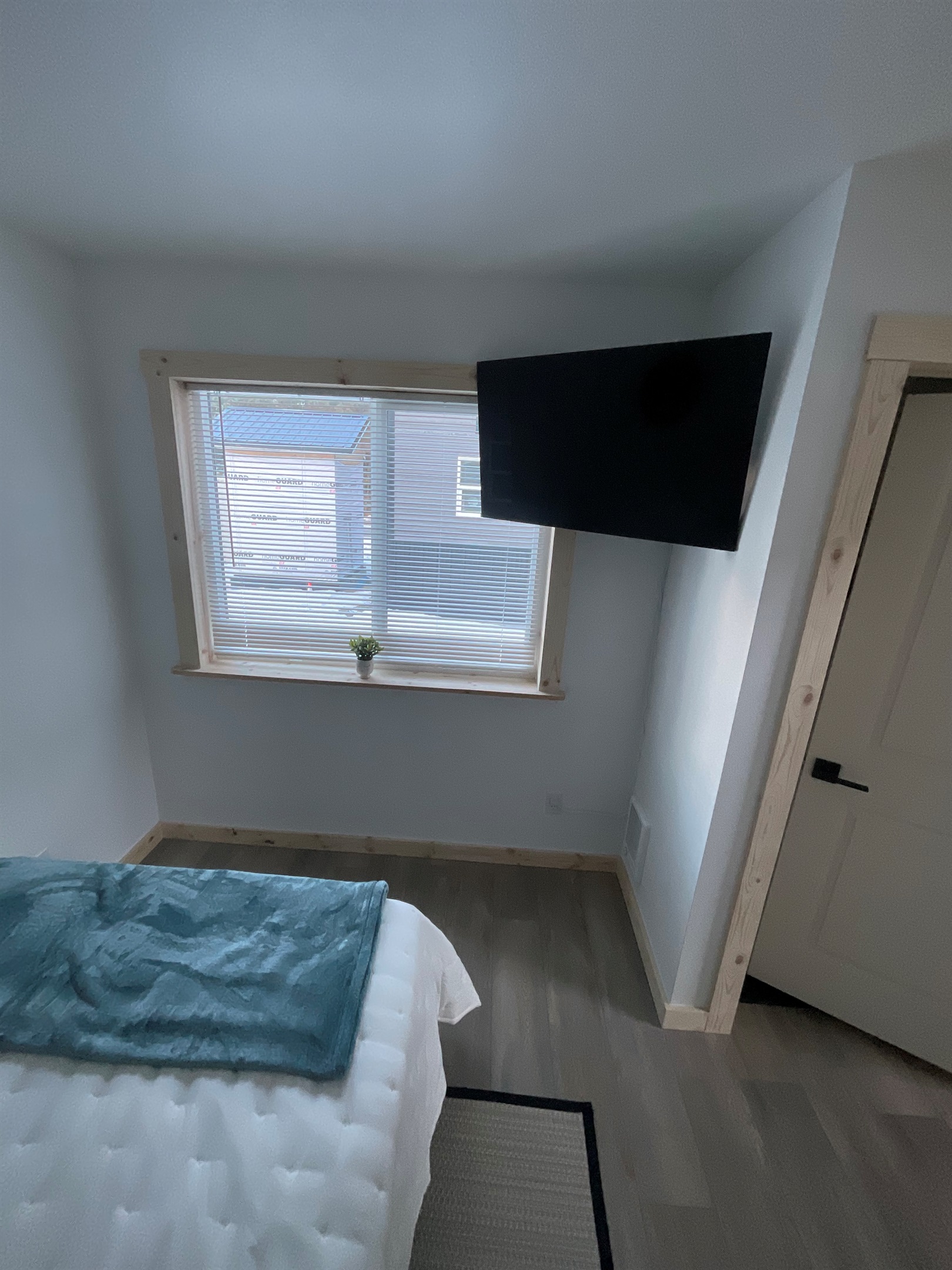 Bedroom on main floor includes a Queen Size Bed with night stand, closet space, and TV. [Photo is representative but may not be from this cabin].