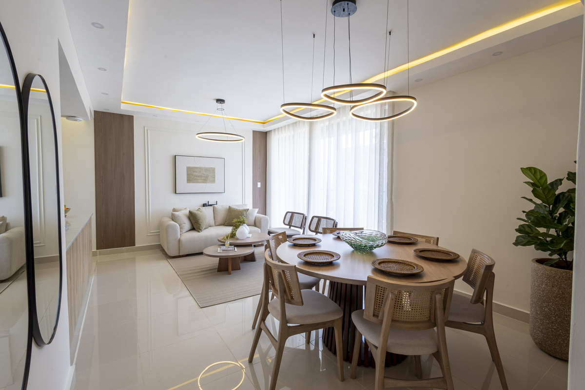 Bright and inviting living space with comfortable seating and floor-to-ceiling balcony windows—perfect for relaxing and enjoying the view. ✨