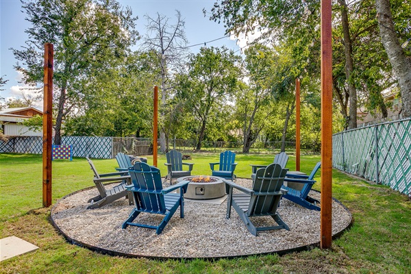 Evenings come alive under string lights around the firepit with seating for 8