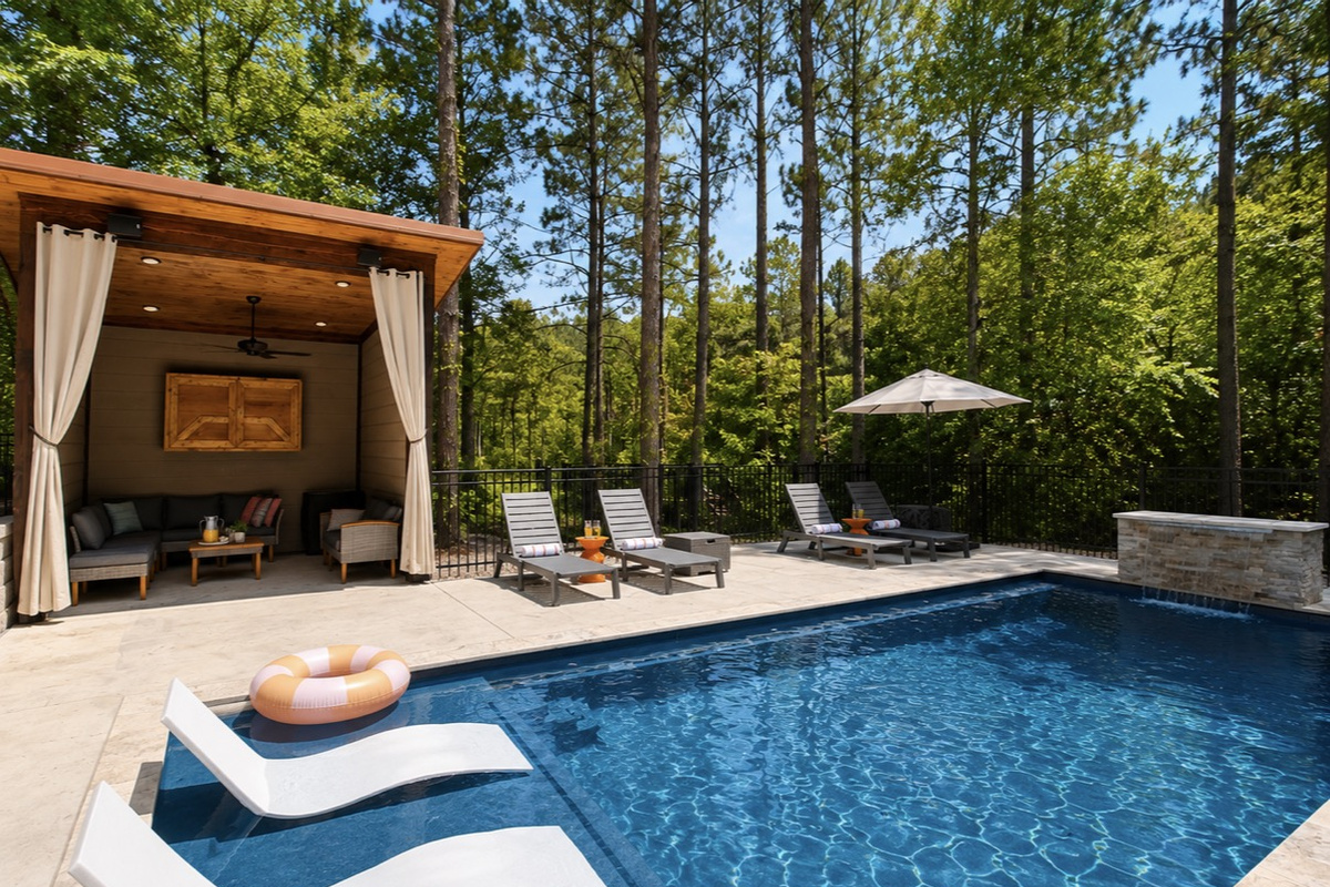 NEW! Resort style heated pool surrounded by towering pines with a spacious tanning ledge, luxury in pool loungers, private cabana lounge, and plenty of space to relax after a day exploring Broken Bow.
