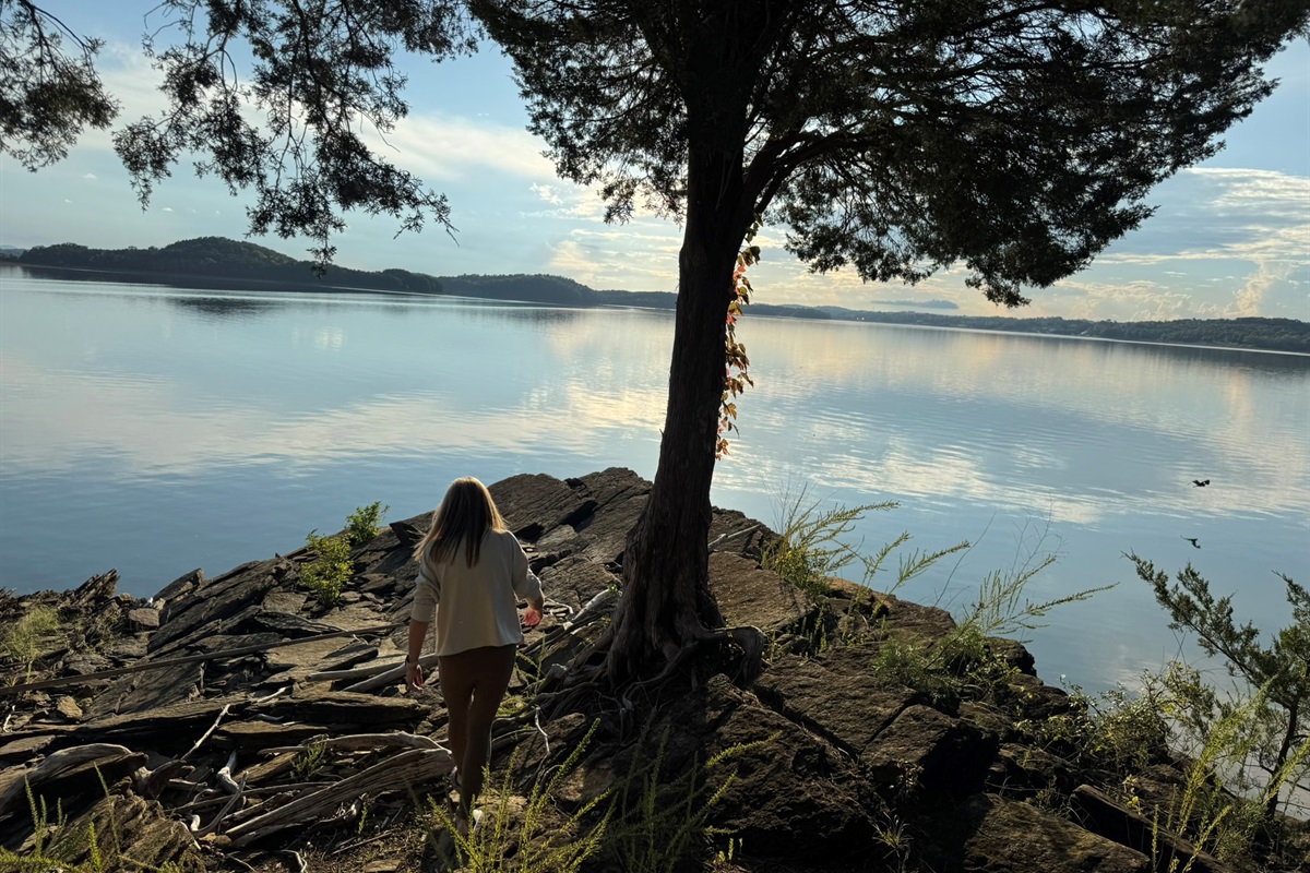 Rocky bluff at end of peninsula, past firepit and seating area