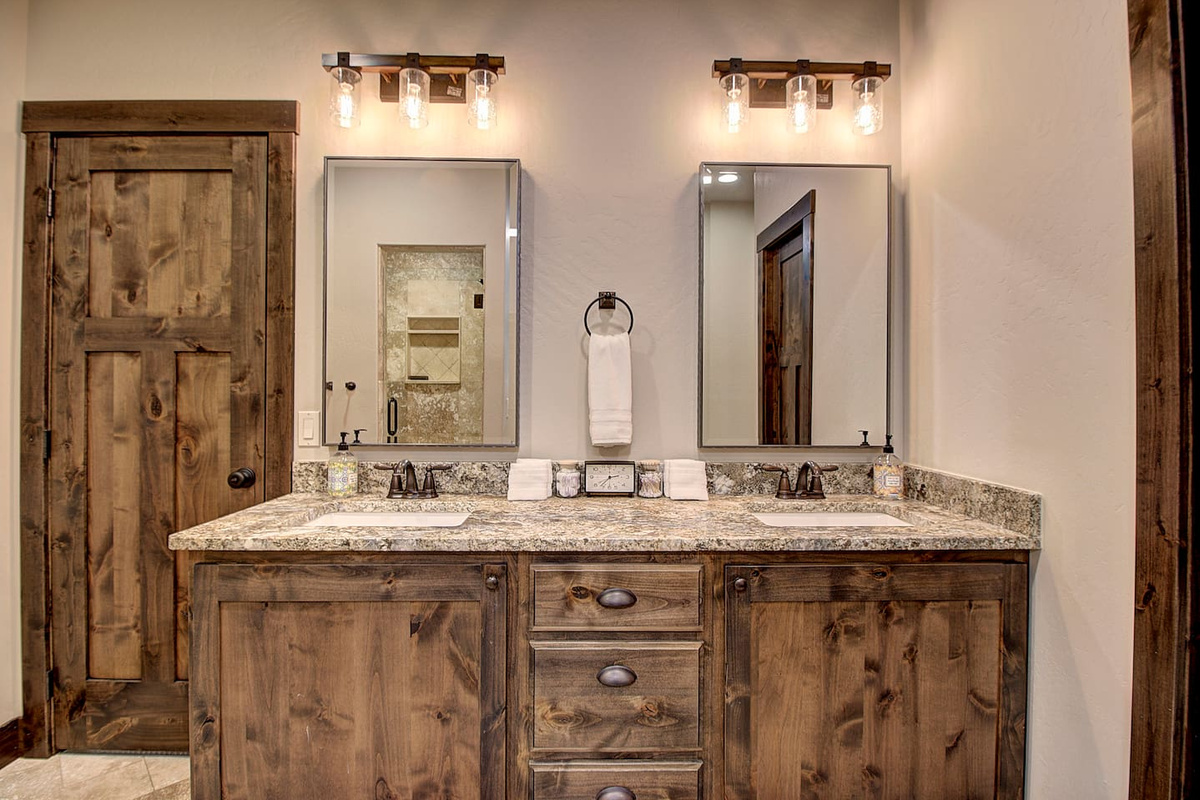Master bathroom featuring a spacious double-sink vanity with rustic wood cabinetry.