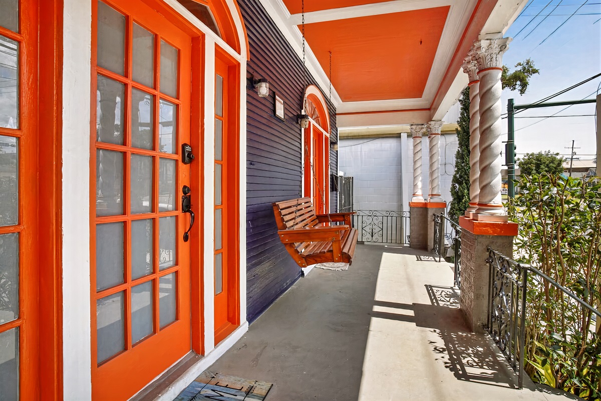 Front covered porch with swinging bench.