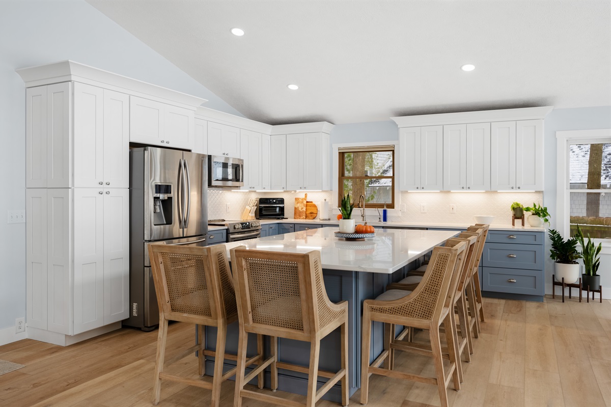 6 barstools surrounding the 10ft island in this newly remodeled kitchen.