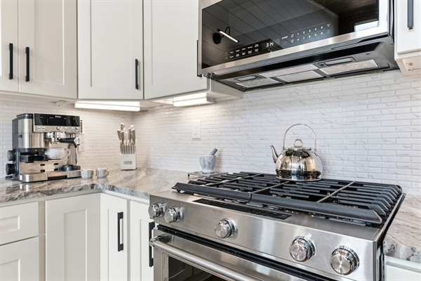 Cook with confidence on this sleek 5-burner stainless gas stove with spacious convection oven. The extra-large microwave makes reheating quick and easy. Everything you need for stress-free gourmet meals!