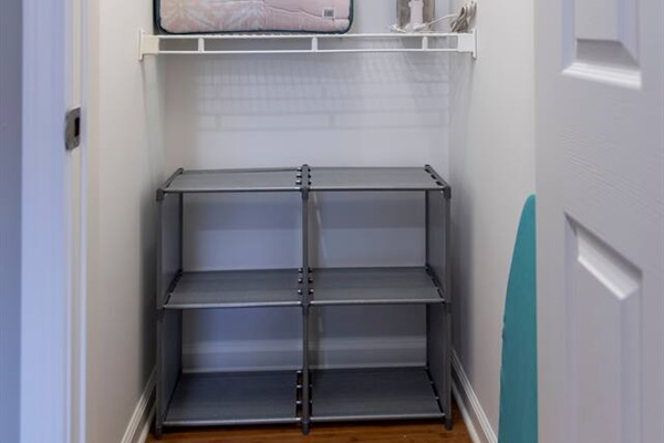 Full closet in Master bedroom with iron and ironing board