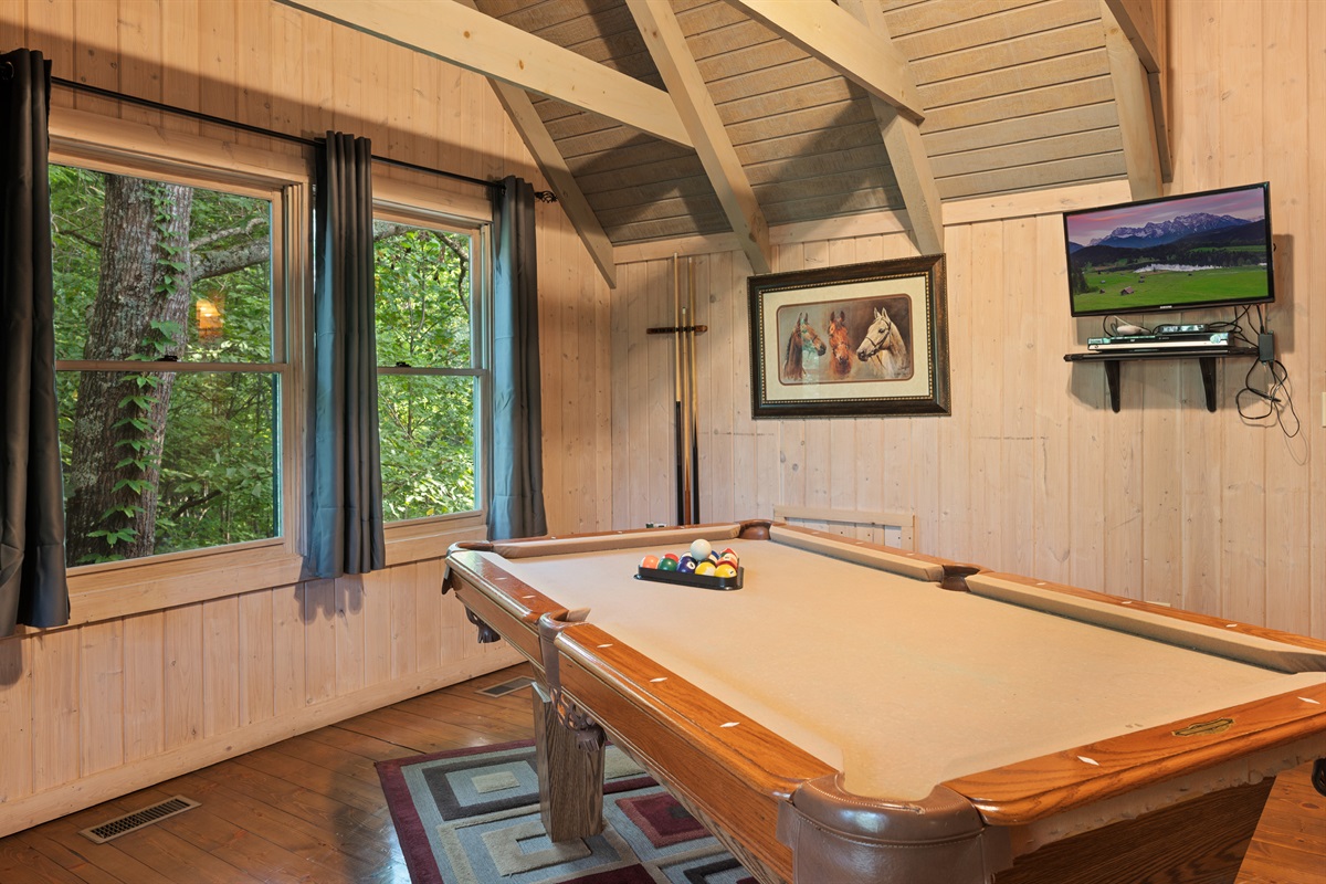 Enjoy endless fun in the loft game room with a pool table and a view!