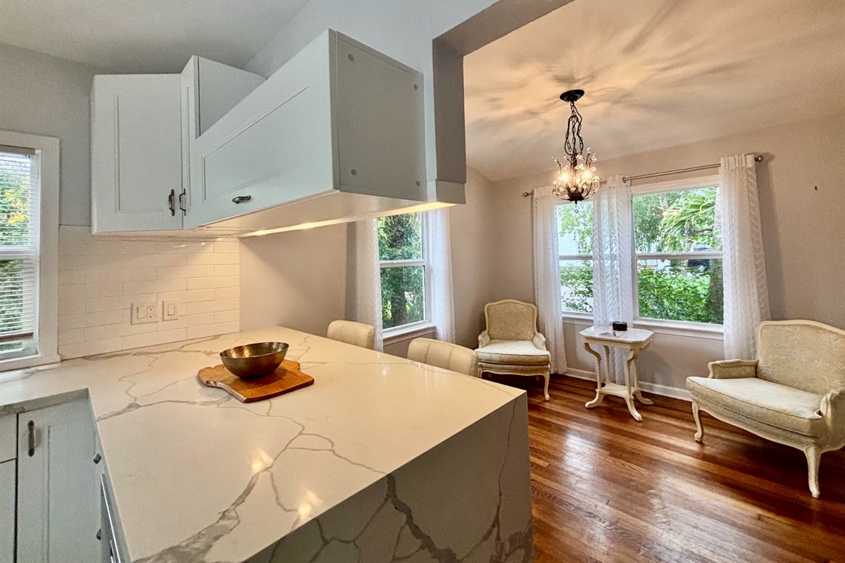 The sitting area off the main kitchen is cozy and well-lit, a wonderful little nook to relax in.
