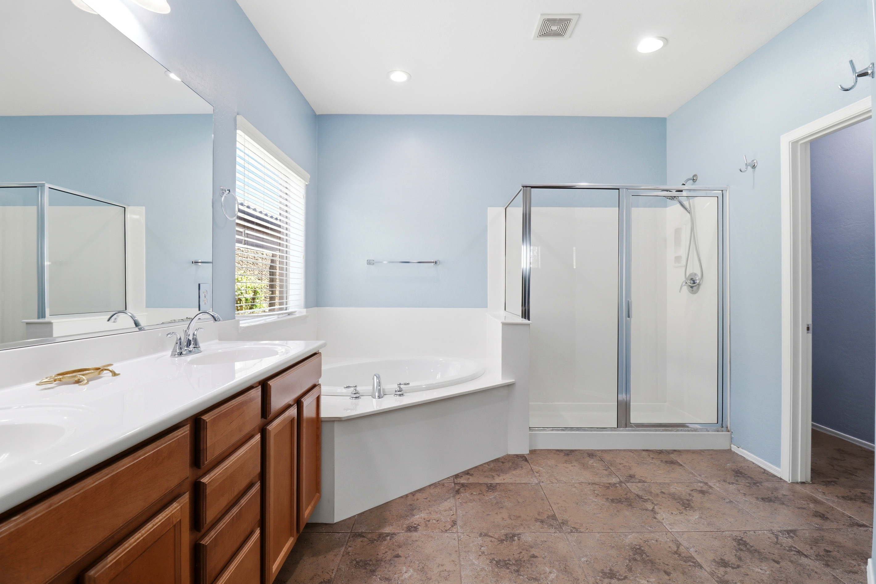 Full bathroom with double sinks, a soaking tub, and a separate shower for an easy daily routine.
