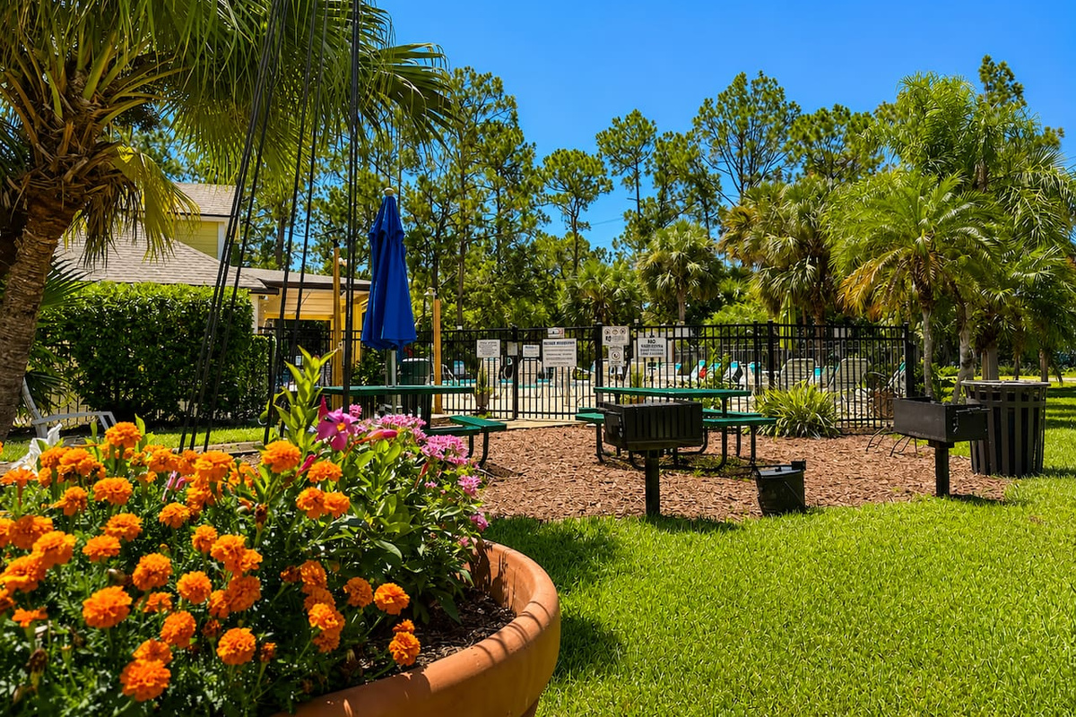 Landscaped community recreation area with shaded seating and space to relax.
