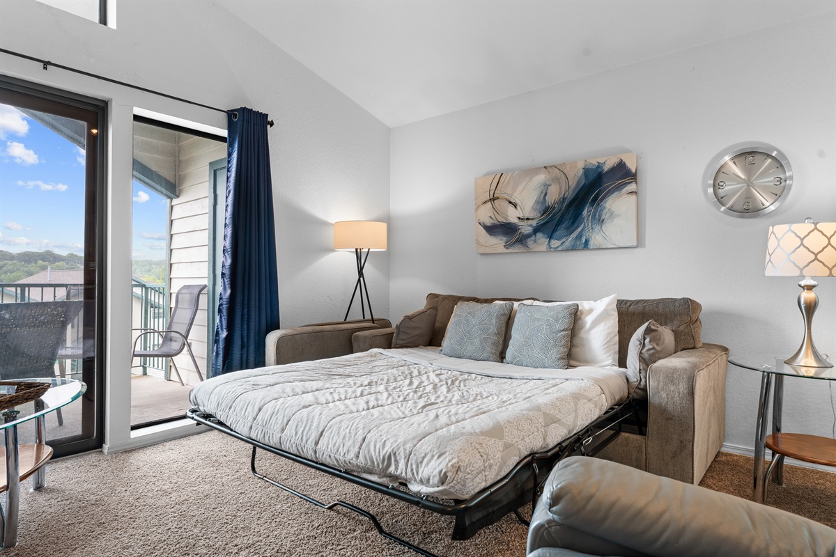 The living room sleeper sofa adds flexible sleeping space without giving up the openness of the main room.