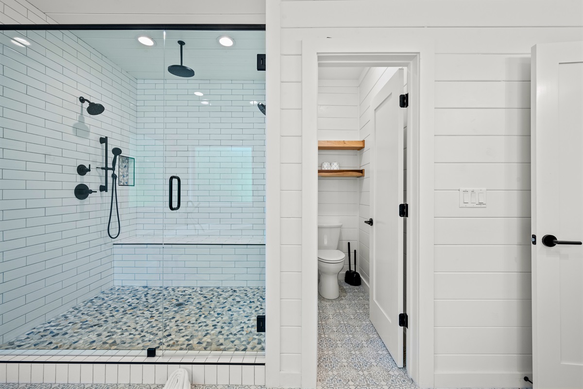 Spacious walk-in shower with dual showerheads.