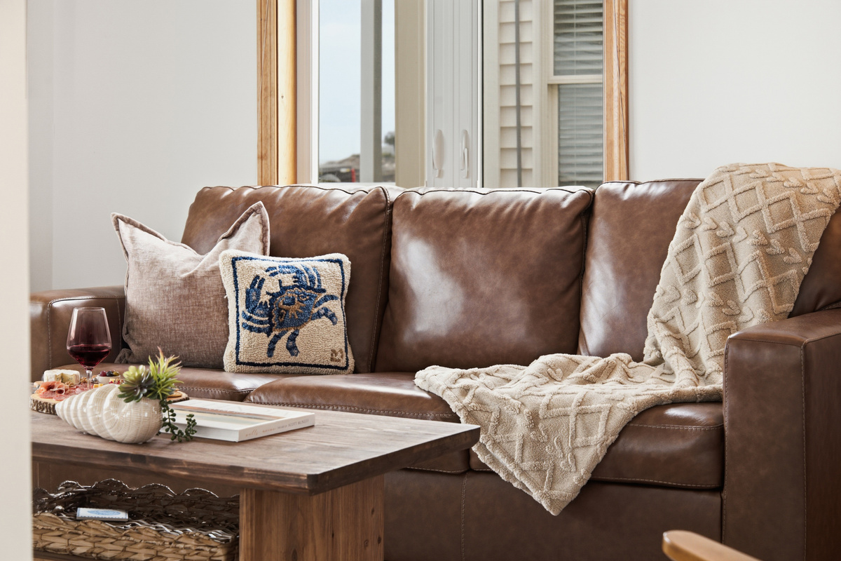 Comfortable leather sofa and cozy living space designed for relaxing after a day at the beach.