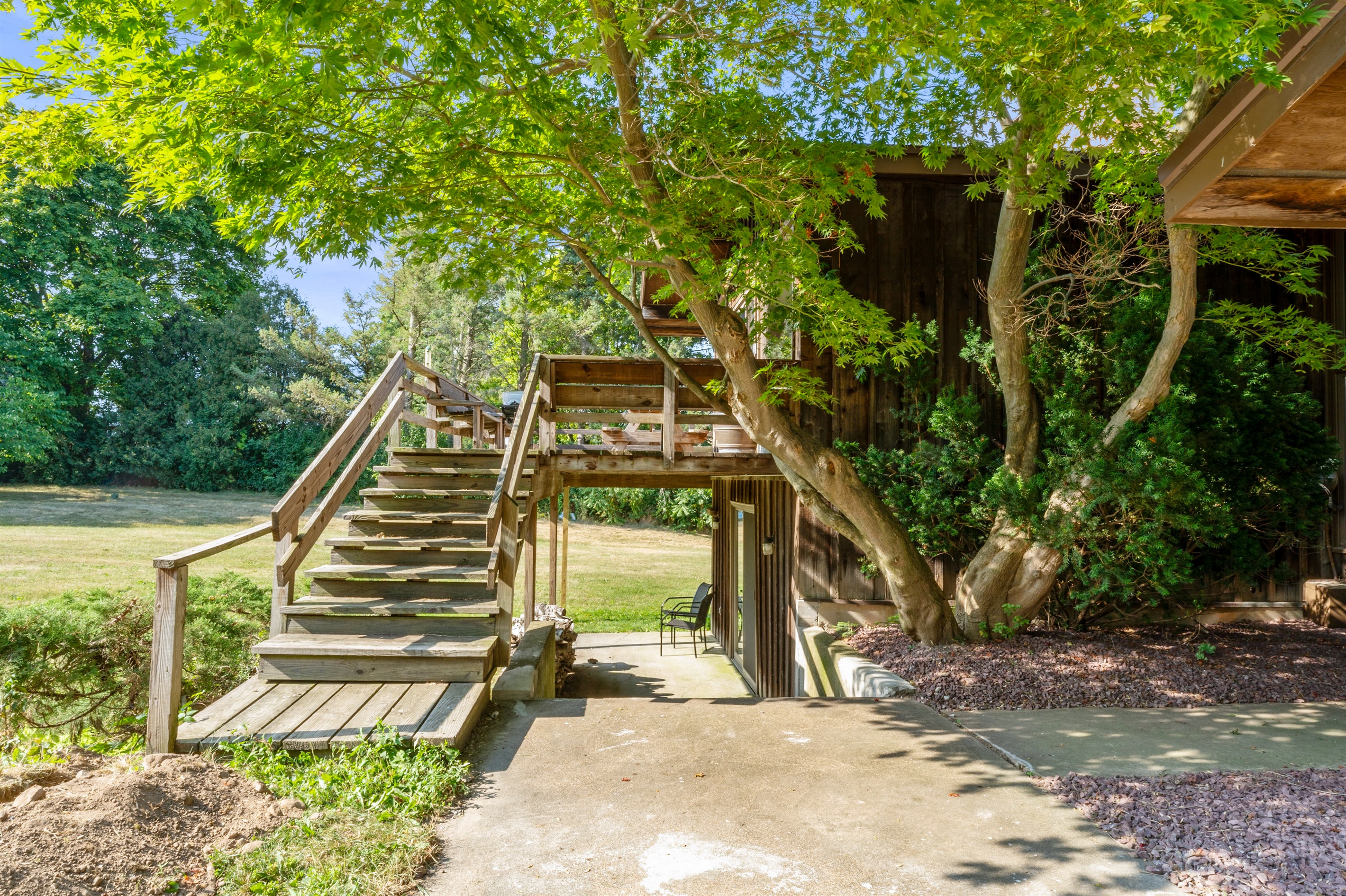 Rustic charm meets open skies at this countryside retreat! Featuring a spacious deck, floor-to-ceiling windows, and natural wood siding, this home is perfect for enjoying panoramic views and peaceful living.