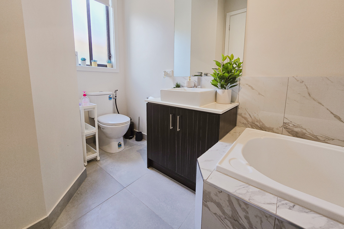 This bathroom at Willows Stays Holiday adds everyday comfort to the stay, with a full bath, vanity and natural light within the home layout.