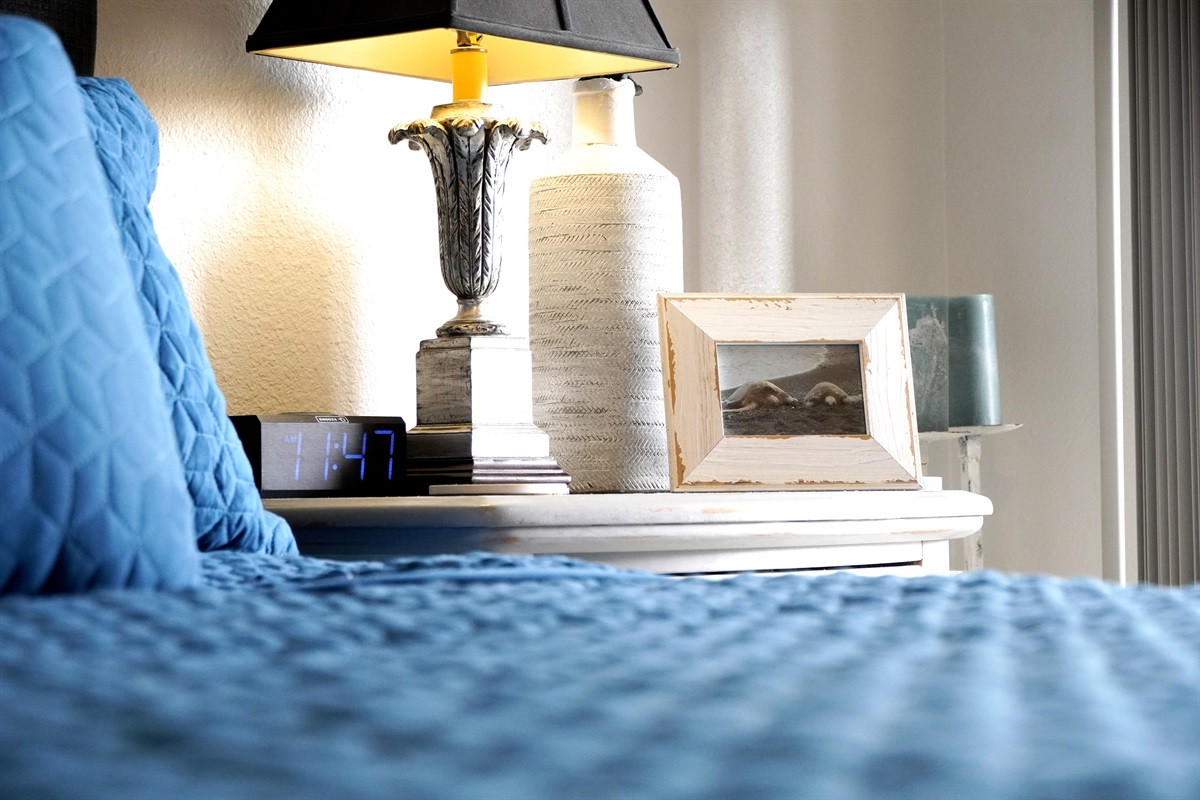 Primary bedroom with cozy bedding and calming beach hues.