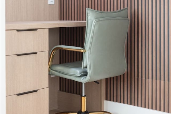 Sleek desk with modern striped accent wall and cozy task lighting.