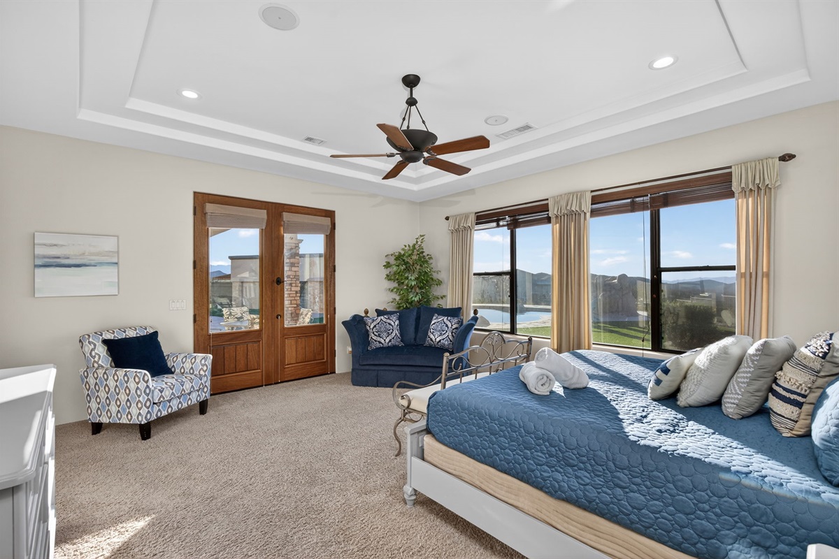 Elegant primary suite with king bed and private sitting space designed for comfort, privacy, and quiet evenings