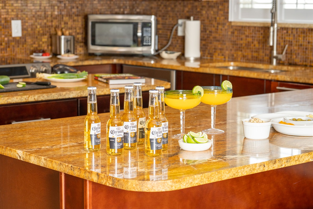 This kitchen features stainless steel appliances, pendant lighting, and an inviting center island perfect for meal prep or casual dining.