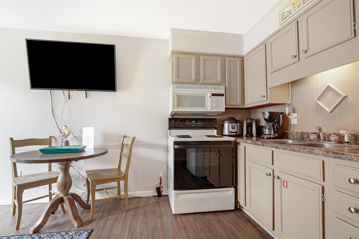 Kitchen - The compact kitchen features all electric appliances, and plenty of items for meal prepping during your stay. No dishwasher is offered in this unit.