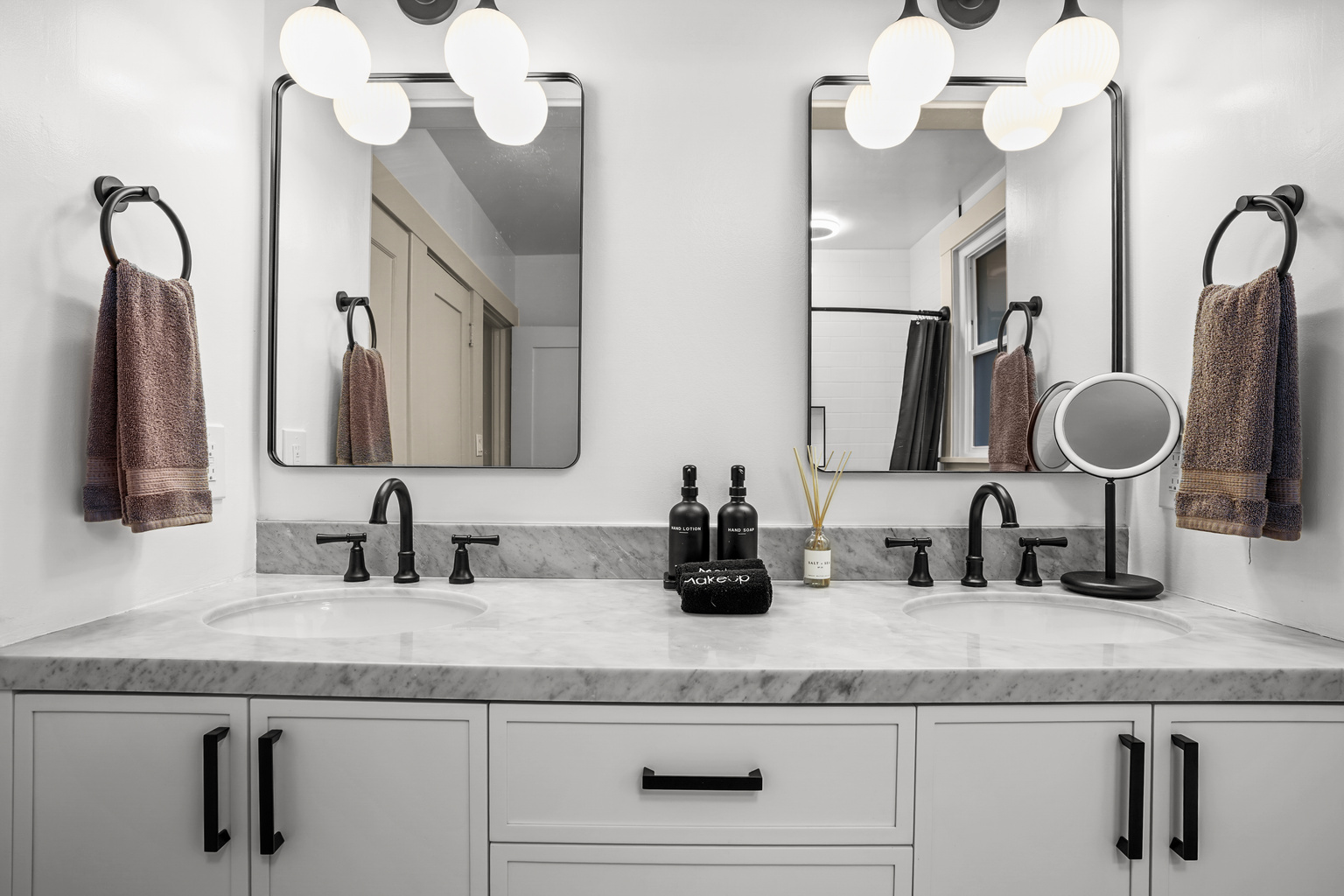 The newly renovated full bathroom downstairs features a double vanity and a bathtub, offering a bright, modern space that's perfect for getting ready or unwinding after a day of exploring Napa Valley.