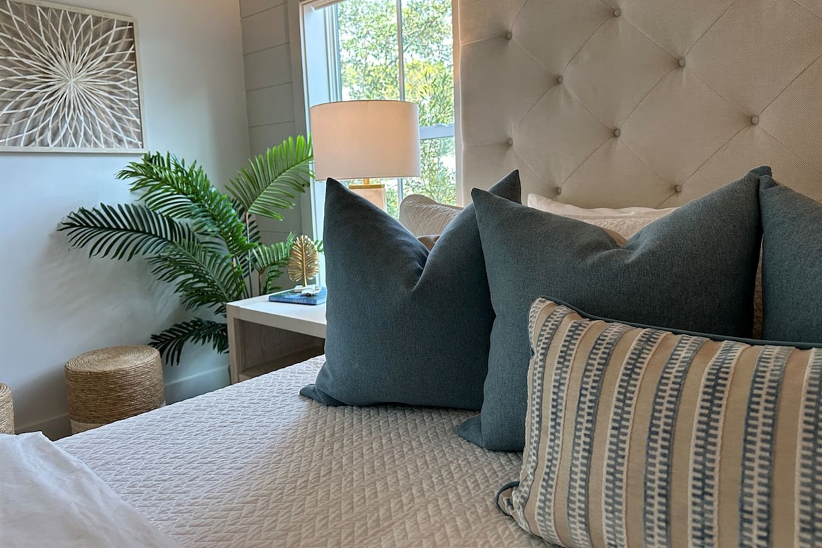 Spacious 2nd level king bedroom suite with full ensuite bathroom, tiled shower, dual vanity sinks, and newly remodeled outdoor shower.