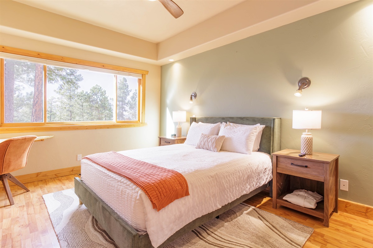 Immerse yourself in nature from our primary bedroom with large windows and a comfortable queen sized bed