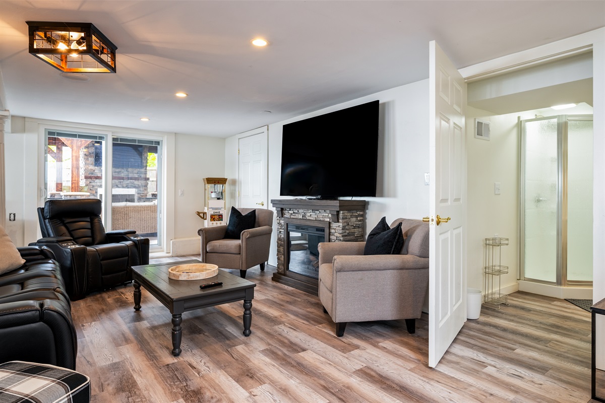 Kick back in this inviting living room with leather recliners, a stone fireplace, and big-screen TV 🔥🎬🛋️