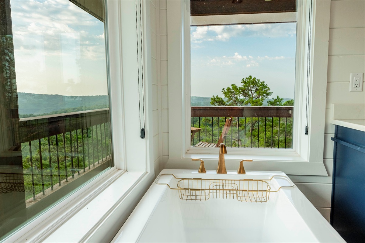 Spa-style soaking tub with peaceful nature views for the perfect unwind